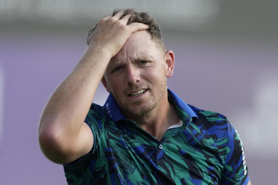 Matt Wallace of England reacts on the 18th hole during the round three of the DP World Tour Championship golf tournament, in Dubai, United Arab Emirates, Saturday, Nov. 18, 2023. (AP Photo/Kamran Jebreili)