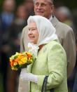 <p>For one of her many 90th birthday outings her majesty opted for this green and white ensemble. [Photo: Getty] </p>