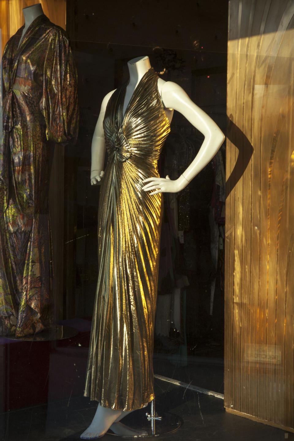 In this photo taken Thursday, Feb. 21, 2013, vintage dresses are displayed in the window of owner Doris Raymond's Hollywood high-end vintage store, "The Way We Wore," in the La Brea District of Los Angeles. Raymond's vintage clothing and accessories store is featured in the reality TV series, "L.A. Frock Stars," which debuts March 7, 2013 on the Smithsonian Channel. (AP Photo/Damian Dovarganes)