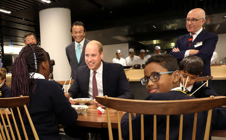 Britain's Prince William joins local school children from St Cuthbert with St Matthias CE Primary School at a copper beating workshop during the official opening of Japan House in London, Britain, September 13, 2018. Tim P. Whitby/Pool via REUTERS