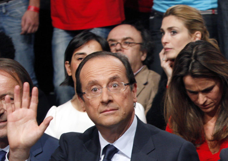 This photo dated Oct. 22, 2011 shows then French Socialist Party candidate for the 2012 presidential elections Francois Hollande, at a nomination ceremony, in Paris, with French actress Julie Gayet in background, top right. Hollande's first lady, journalist Valerie Trierweiler was hospitalized last Friday after a tabloid-style magazine reported that he is secretly having an affair with French movie actress Gayet, and published photos it said proved the liaison. (AP Photo/Thibault Camus)