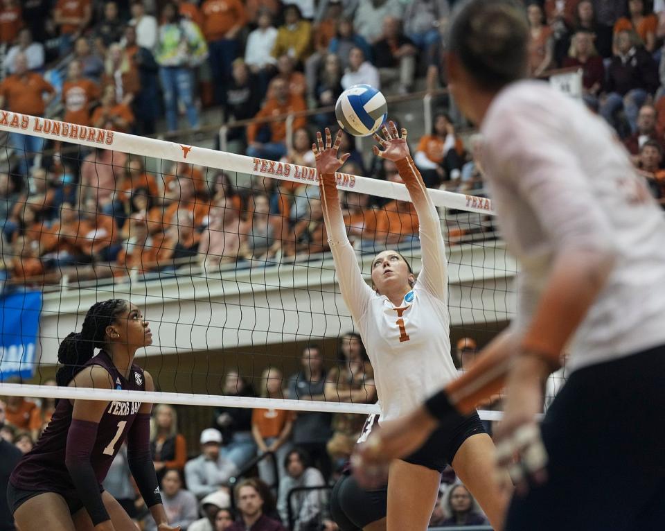 Texas setter Ella Swindle (1) sets her teammate up for a hit during the NCAA game against Texas A&M at Gregory Gymnasium on Thursday, Nov. 30, 2023.