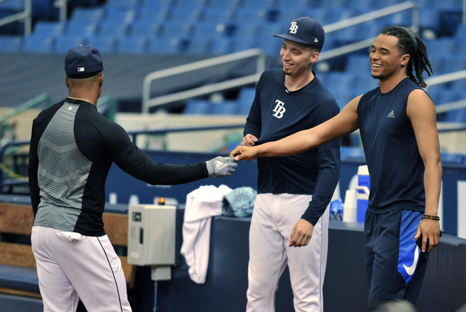 Tampa Bay Rays' Chris Archer, right talks with Mallex Smith, left, and Blake Snell, center, in the bullpen after he was traded to the Pittsburgh Pirates Tuesday, July 31, 2018, in St. Petersburg, Fla. The Pirates bolstered the front end of their rotation at the non-waiver deadline, adding Archer while sending the Rays a couple of coveted prospects in outfielder Austin Meadows and pitcher Tyler Glasnow and a player to be named. (AP Photo/Steve Nesius)