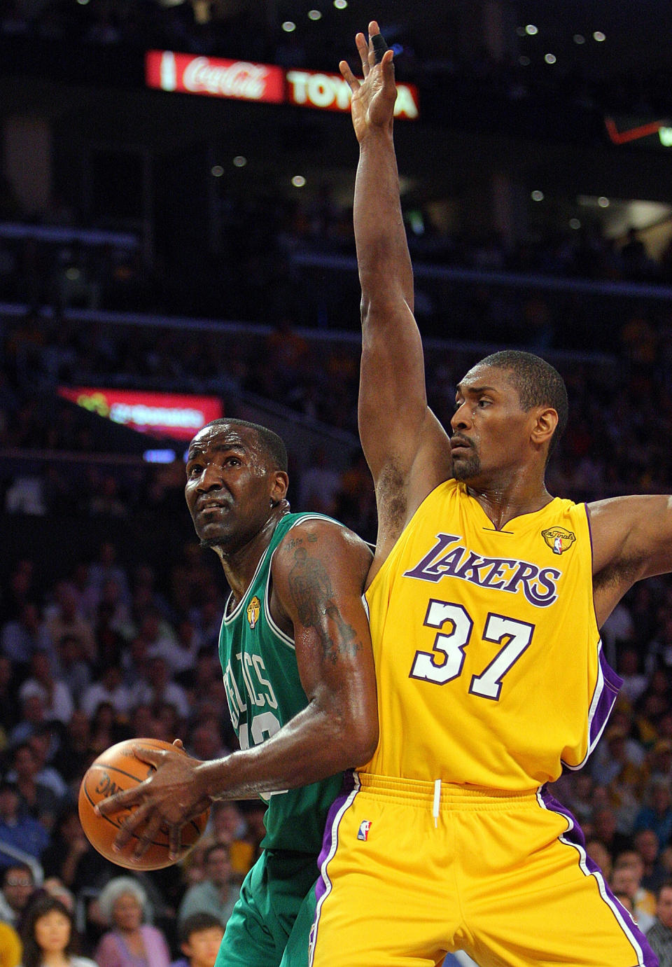 Metta World Peace guards an offensive player during a Laker game.