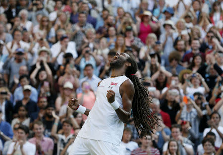 Dustin Brown of Germany celebrates after winning his match against Rafael Nadal of Spain at the Wimbledon Tennis Championships in London, July 2, 2015. REUTERS/Stefan Wermuth