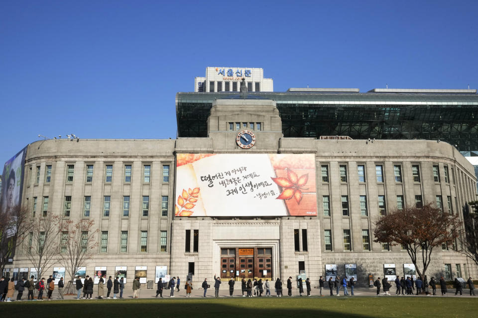 People queue in line to wait for the coronavirus testing at a makeshift testing site in Seoul, South Korea, Wednesday, Nov. 24, 2021. New coronavirus infections in South Korea exceeded 4,000 in a day for the first time since the start of the pandemic as a delta-driven spread continues to rattle the country after it eased social distancing in recent weeks to improve its economy. (AP Photo/Ahn Young-joon).