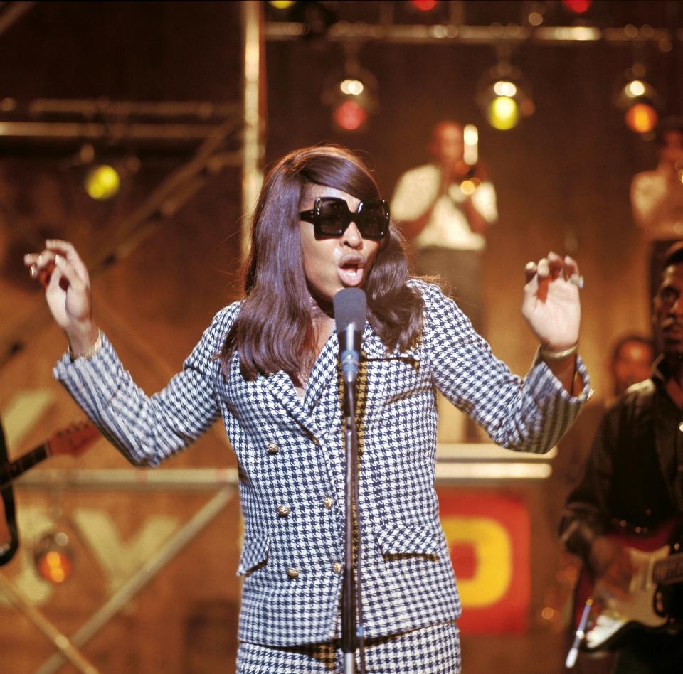 singing on stage with sunglasses on