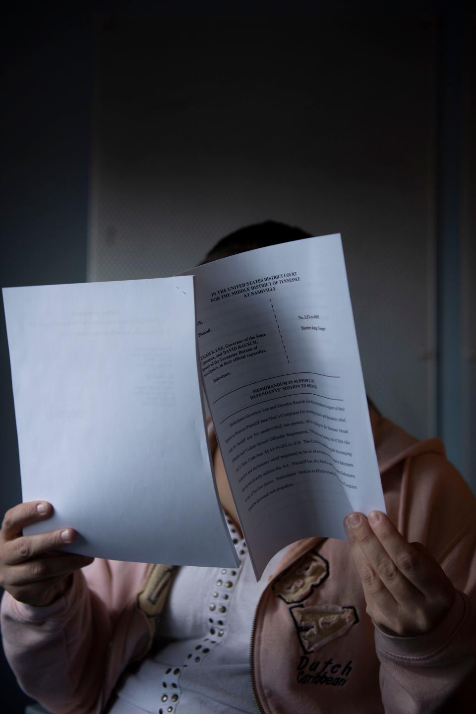 A woman reads her lawsuit challenging her lifelong classification as a violent sexual offender despite never being convicted of a sexual offense at her attorney's office in Nashville, Tenn., on Wednesday, Oct. 18, 2023.