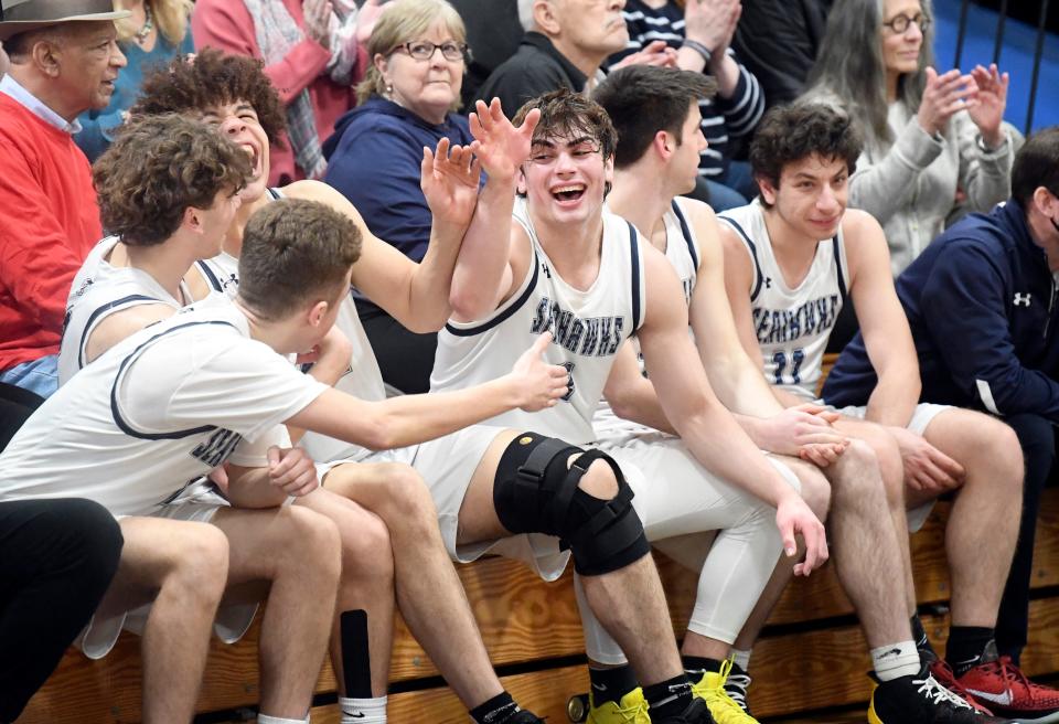 With starters on the bench and a large lead, Jaeden Greenleaf (center) celebrates with his Cape Cod Academy teammates during their game with Carver in the MIAA Div. 4 round of 32 basketball game March 4.