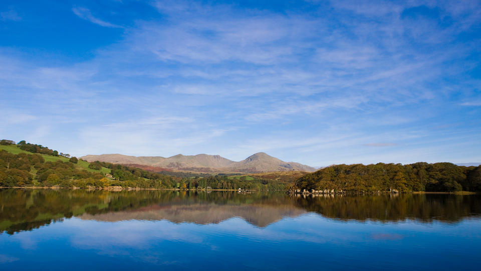 The Old Man of Coniston mountain reflected in Coniston Water