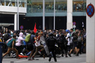 Riot policemen clash with protestors outside El Prat airport in Barcelona, Spain, Monday, Oct. 14, 2019. Riot police have charged at protesters outside Barcelona's airport after the Supreme Court sentenced 12 prominent Catalan separatists to lengthy prison terms for their roles in a 2017 push for the wealthy Spanish region's independence. (AP Photo/Emilio Morenatti)