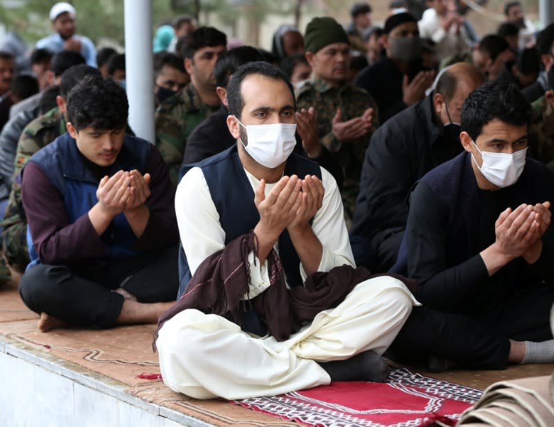 Muslims wearing protective masks attend Friday prayers at a mosque, amid concerns about the spread of coronavirus disease (COVID-19), in Kabul