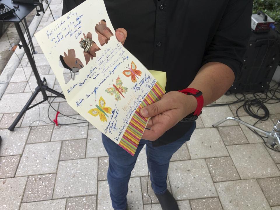 Mike Noriega shows a birthday card, Saturday, June 26, 2021, in Surfside, Fla., relatives sent to his grandmother, Hilda Noriega, two weeks ago for her 92nd birthday. Hilda Noriega lives on the sixth floor of the Miami building that collapsed. (AP Photo/Joshua Goodman)