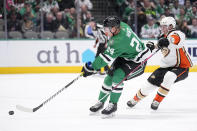 Dallas Stars center Roope Hintz (24) shoots at the net as Anaheim Ducks defenseman John Klingberg (3) defends on the play in the first period of an NHL hockey game, Monday, Feb. 6, 2023, in Dallas. (AP Photo/Tony Gutierrez)