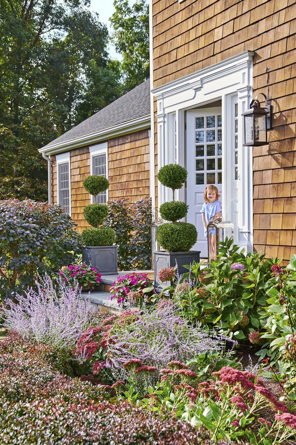 <p>Topiaries are a staple of New England landscaping. They're especially fitting in the colorful garden of this quite-nice Connecticut farmhouse. </p><p><strong><a href="https://www.countryliving.com/home-design/house-tours/g16639267/debbie-propst-connecticut-farmhouse/" rel="nofollow noopener" target="_blank" data-ylk="slk:Read more about the Connecticut farmhouse;elm:context_link;itc:0;sec:content-canvas" class="link ">Read more about the Connecticut farmhouse</a>.</strong></p><p><a class="link " href="https://go.redirectingat.com?id=74968X1596630&url=https%3A%2F%2Fwww.etsy.com%2Flisting%2F725987428%2Fcustom-preserved-boxwood-topiary-double&sref=https%3A%2F%2Fwww.countryliving.com%2Fgardening%2Fgarden-tours%2Fg1432%2Flandscaping-ideas%2F" rel="nofollow noopener" target="_blank" data-ylk="slk:SHOP TOPIARIES;elm:context_link;itc:0;sec:content-canvas">SHOP TOPIARIES</a></p>