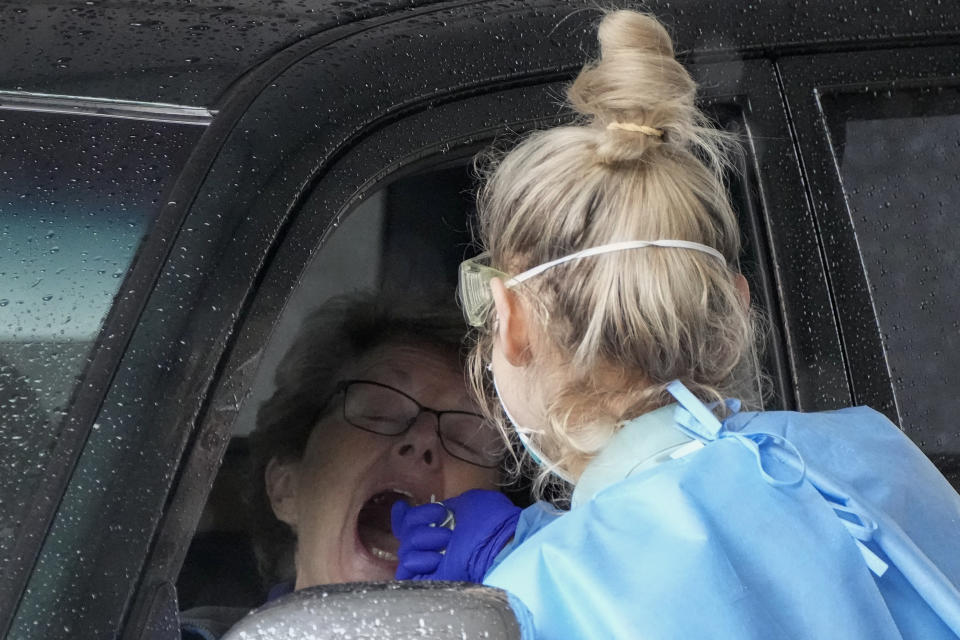 A woman receives a COVID-19 test at a testing station in Nelson Bay, Australia, Monday, June 28, 2021. Australia was battling to contain several COVID-19 clusters around the country on Monday in what some experts have described as the nation’s most dangerous stage of the pandemic since the earliest days. (AP Photo/Mark Baker)