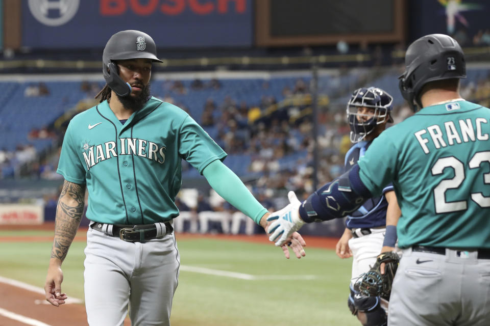 Seattle Mariners' J.P. Crawford, left, celebrates with teammate Ty France after scoring against the Tampa Bay Rays during the first inning of a baseball game Saturday, Sept. 9, 2023, in St. Petersburg, Fla. (AP Photo/Scott Audette)