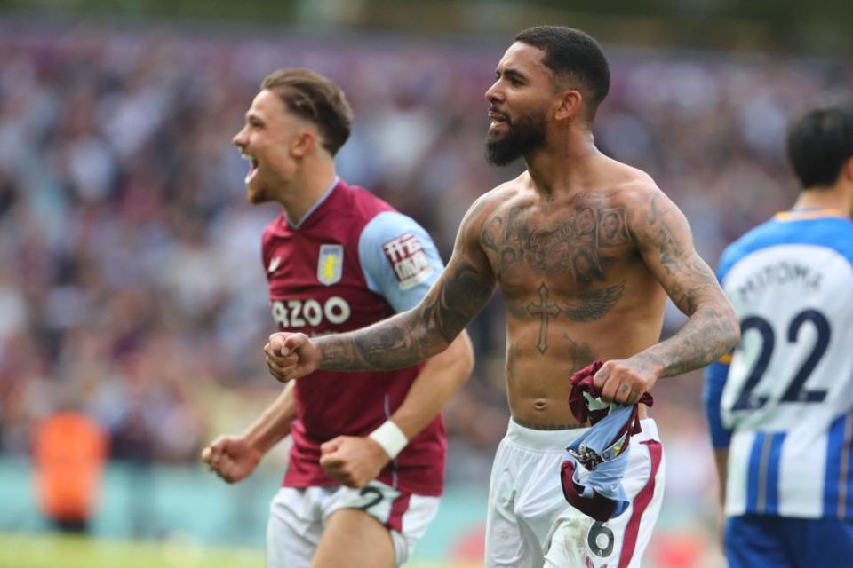 Aston Villa's English defender Matty Cash (L) and Aston Villa's Brazilian midfielder Douglas Luiz (R) celebrate on the final whistle in the English Premier League football match between Aston Villa and Brighton and Hove Albion at Villa Park in Birmingham, central England on May 28, 2023. Villa won the game 2-1. (Photo by Geoff Caddick / AFP)