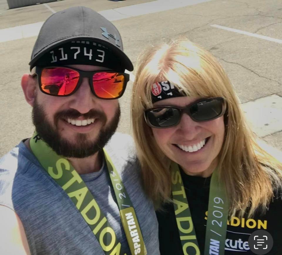 A 2019 photo shows Debbie McGee and her late son, Erinn McGee, at a Spartan Race at Angel Stadium in Anaheim.