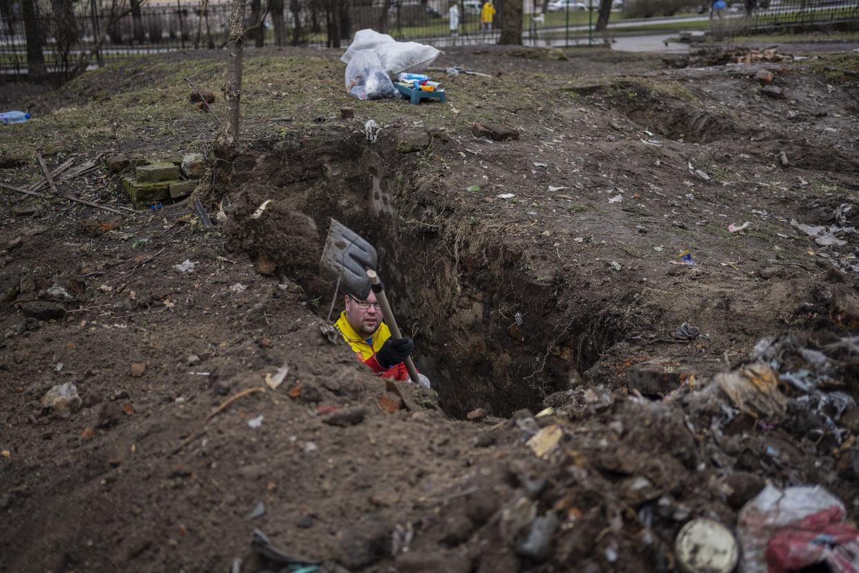 A Ukrainian volunteer removes rubble to open up an abandoned shelter, in Lviv, western Ukraine, Thursday, March 3, 2022.