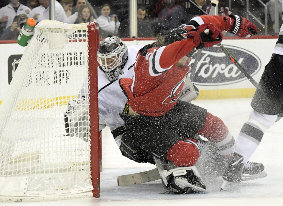 New Jersey Devils center Blake Coleman (20) crashes into Los Angeles Kings goaltender Calvin Petersen (40) during the second period of an NHL hockey game Saturday, Feb. 8, 2020, in Newark, N.J. (AP Photo/Bill Kostroun)