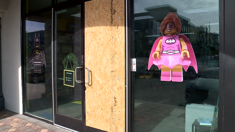 <em>One of Bricks and Minifigs boarded up after a Sunday morning break in, just a few months after replacing the other door for a similar crime. (KLAS)</em>