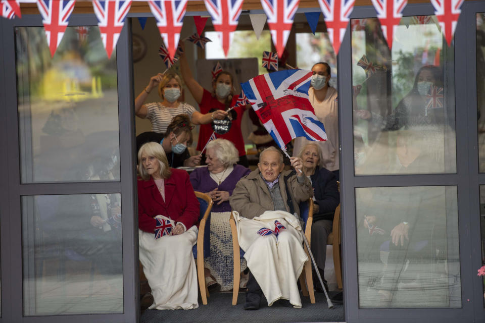 Residents wave to Britain's Prince William and Kate, Duchess of Cambridge as they visit Cleeve Court Care Home in Bath, England, Tuesday Dec. 8, 2020, on the final day of a three-day tour across the country. (Paul Grover/Pool via AP)