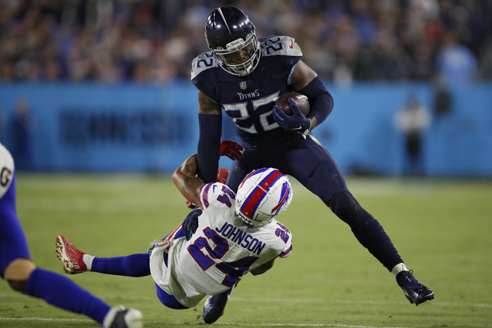 NASHVILLE, TENNESSEE - OCTOBER 18: Running back Derrick Henry #22 of the Tennessee Titans rushes in front of cornerback Taron Johnson #24 of the Buffalo Bills during the second half at Nissan Stadium on October 18, 2021 in Nashville, Tennessee. (Photo by Wesley Hitt/Getty Images)