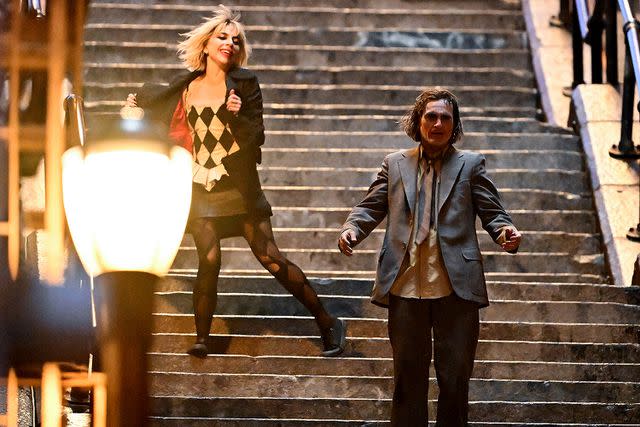 <p>James Devaney/GC Images</p> Lady Gaga and Joaquin Phoenix filming Joker: Folie à Deux on April 3, 2023