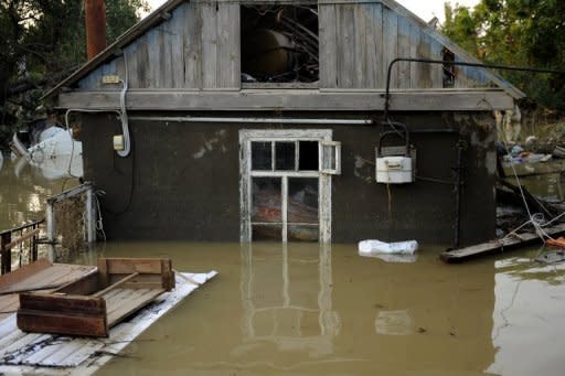 A flooded house stands in the southern Russian town of Krymsk. First funerals were held in the town of Krymsk, the worst hit area in southern Krasnodar region, as emergency workers pulled more bodies from the debris and survivors insisted they had not received any flood warning