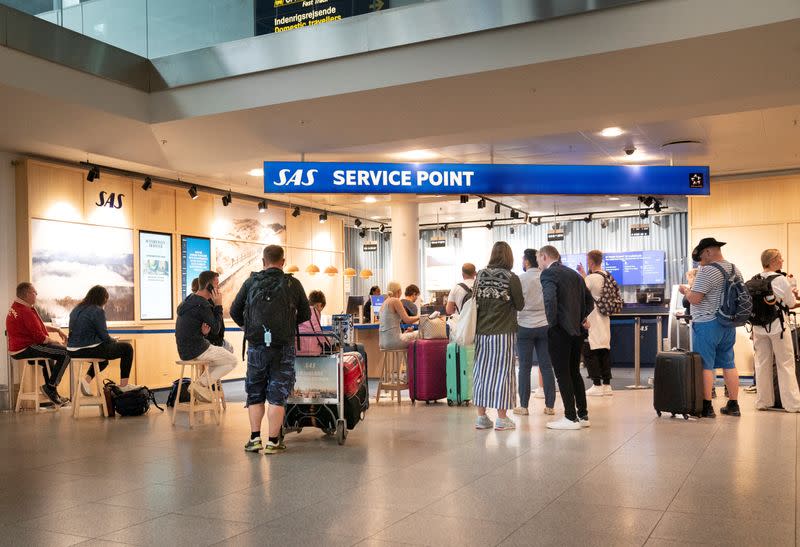 Passengers wait at the airport during a pilot strike at Copenhagen Airport