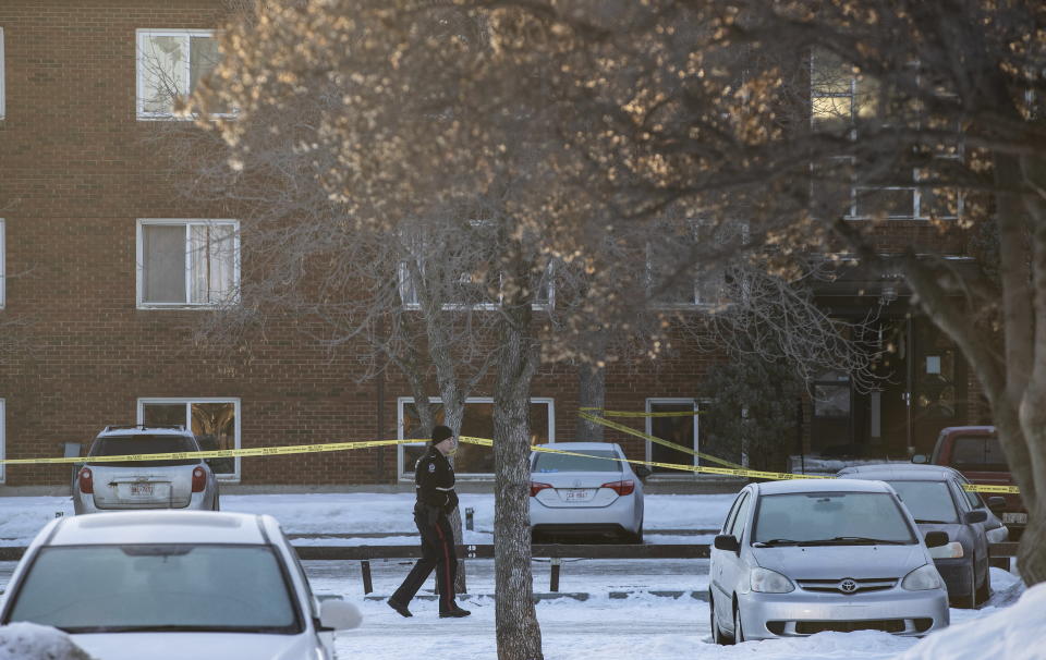 Police investigate the scene where two officers were shot and killed on duty in Edmonton on Thursday, March 16, 2023. (Jason Franson/The Canadian Press via AP)