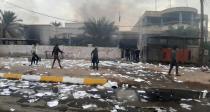 Demonstrators are seen near the office of the shiite endowment after it was set on fire by protesters during ongoing anti-government protests in Nassiriya