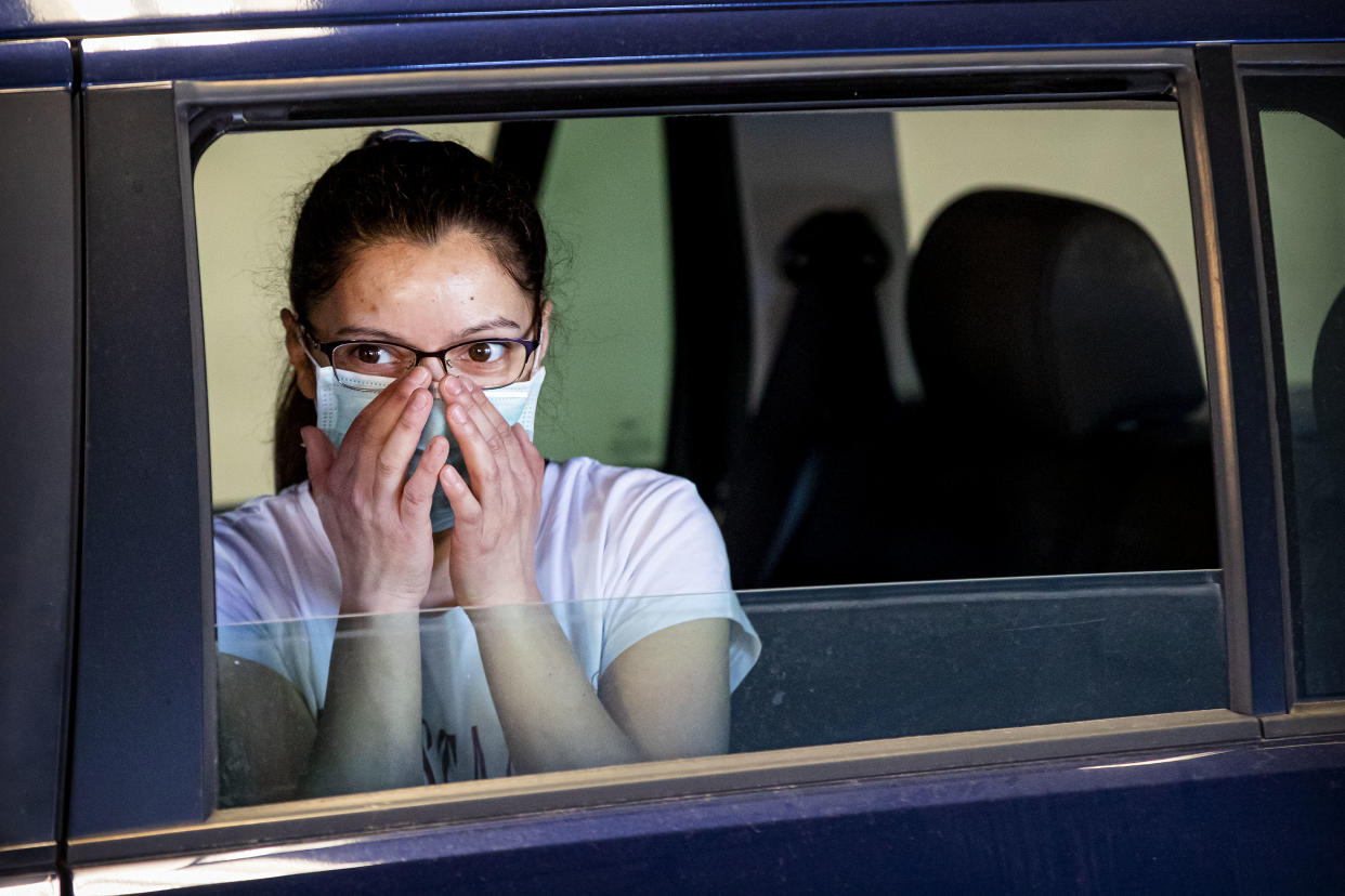 DORDRECHT, NETHERLANDS - APRIL 21: A girl with a face masks watches as Medical staff from the Medical Service Dordrecht test people with symptoms of COVID-19 at a drive in location on April 21, 2020 in Tiel, Netherlands. The price of the test is 70 euros. Instead of adopting a hard lockdown similar to its European neighbours, the Netherlands opted for a targeted lockdown, which allows some shops to continue if there was a low risk of spreading the virus. The coronavirus (COVID-19) pandemic has spread to many countries across the world, claiming over 176,000 lives and infecting more than 2.5 million people. (Photo by Patrick van Katwijk/Getty Images)