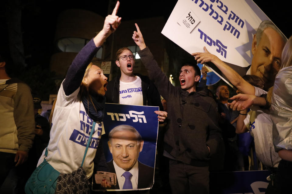 Supporters of Israeli Prime Minister Benjamin Netanyahu gather outside his residence in Jerusalem, Thursday, Nov. 21, 2019. Israel's attorney general charged Netanyahu with fraud, breach of trust and accepting bribes in three different scandals. It is the first time a sitting Israeli prime minister has been charged with a crime. (AP Photo/Ariel Schalit)