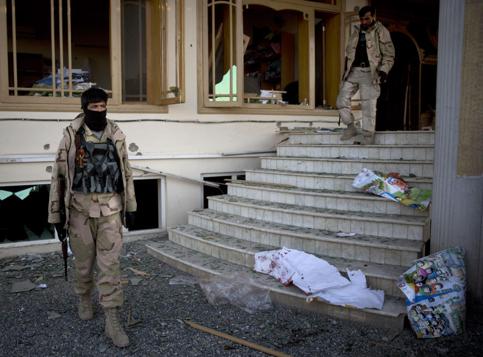 Destroyed and blood covered election posters are littered on the stairs as Afghan Army soldiers search an election office after the Taliban launched an assault with a suicide bomber detonating his vehicle outside an election office in Kabul, Afghanistan, Tuesday, March 25, 2014. Gunmen stormed into the building, trapping dozens of employees inside and killing many people. A candidate for a seat on a provincial council was among those killed, along with an election worker, a civilian and a policeman. (AP Photo/Anja Niedringhaus)