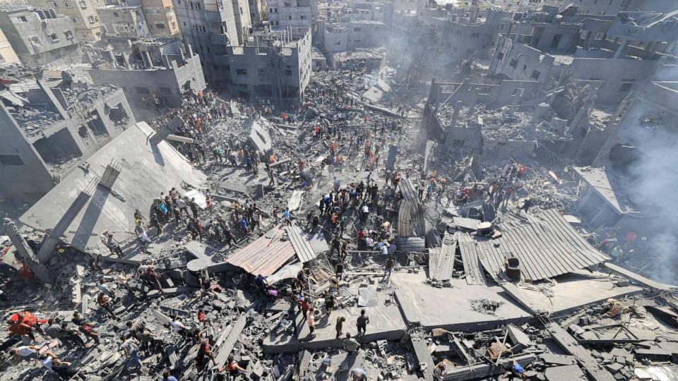 PHOTO: People search for survivors and the bodies of victims through the rubble of buildings destroyed during Israeli air strike, in Khan Yunis in the southern Gaza Strip, Oct. 26, 2023. (Mahmud Hams/AFP via Getty Images)