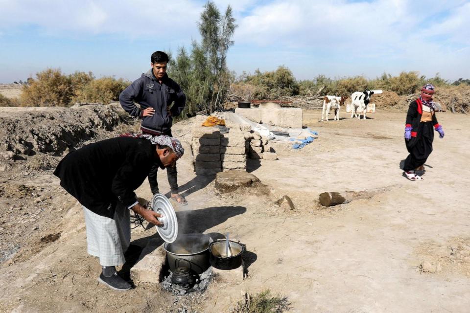 PHOTO: An Iraqi farmer cooks next to a dried-up irrigation canal at his farm affected by drought, in the south of Babil province, central Iraq, January 8, 2024. (Ahmed Jalil/EPA via Shutterstock)