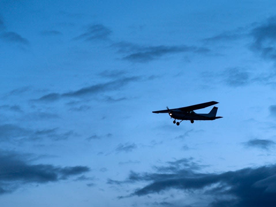 Plane flying in Alaska at dusk.