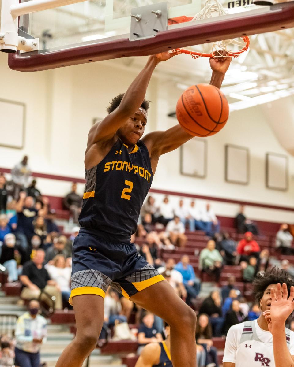 Stony Point's Josiah Moseley dunks the ball in a game against Round Rock last season.  The 6-foot-6 junior returns for the Tigers after earning first-team, all-Centex honors a year ago.
