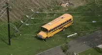 Utility wires cover a school bus after severe weather passed the area on Wednesday, July 19, 2023 in Rocky Mount, N.C. (WTVD via AP)