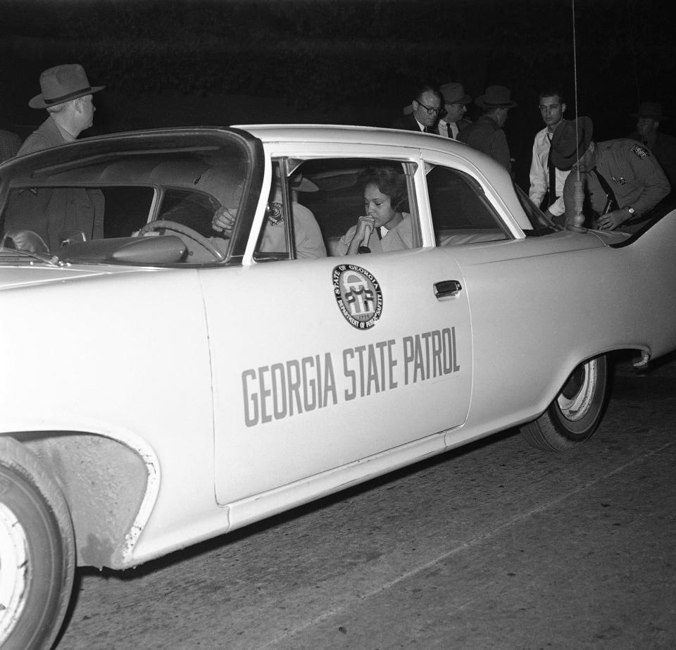 Charlayne Hunter, 18, who started classes at the University of Georgia under federal order, was escorted by a highway patrol officer for her own protection when students staged an uprising against the integration  Jan. 12, 1961.