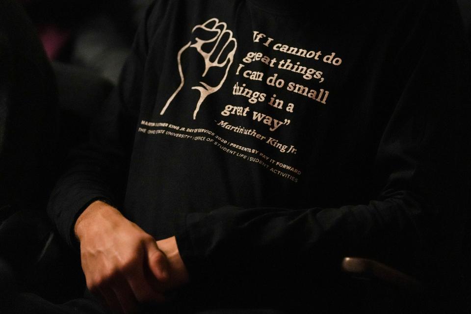 A person sits in the audience during the "MLK Day Open House Celebration" at the Ohio History Center Monday. The program featured dance, music, spoken word and theater performances to honor Martin Luther King Jr.'s legacy.