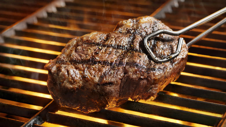 Steak cooking on a grill