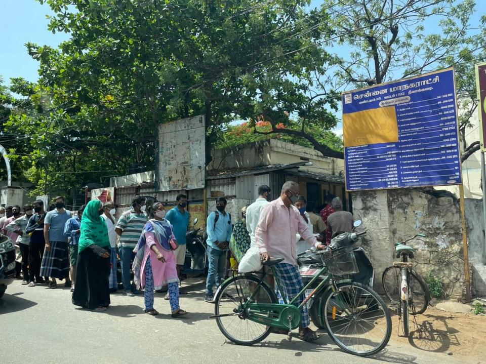 Chennai’s locals form a queue for ration.