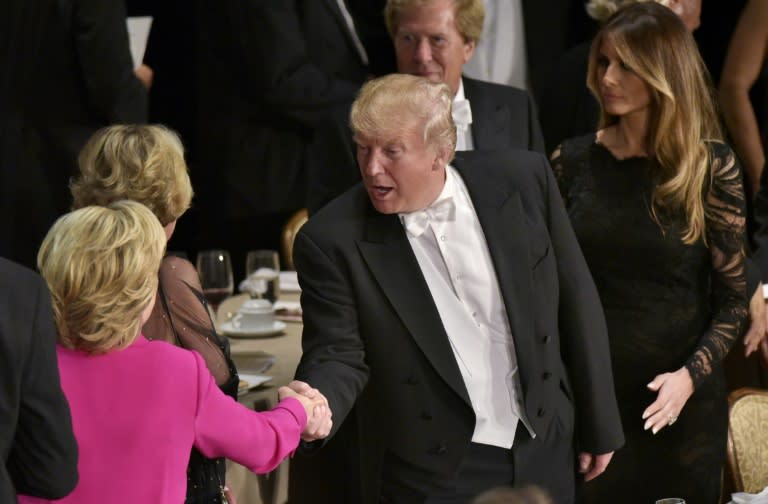 Republican presidential nominee Donald Trump shakes hands with Democratic rival Hillary Clinton during the Alfred E. Smith Memorial Foundation Dinner at the Waldorf-Astoria Hotel in New York, on October 20, 2016