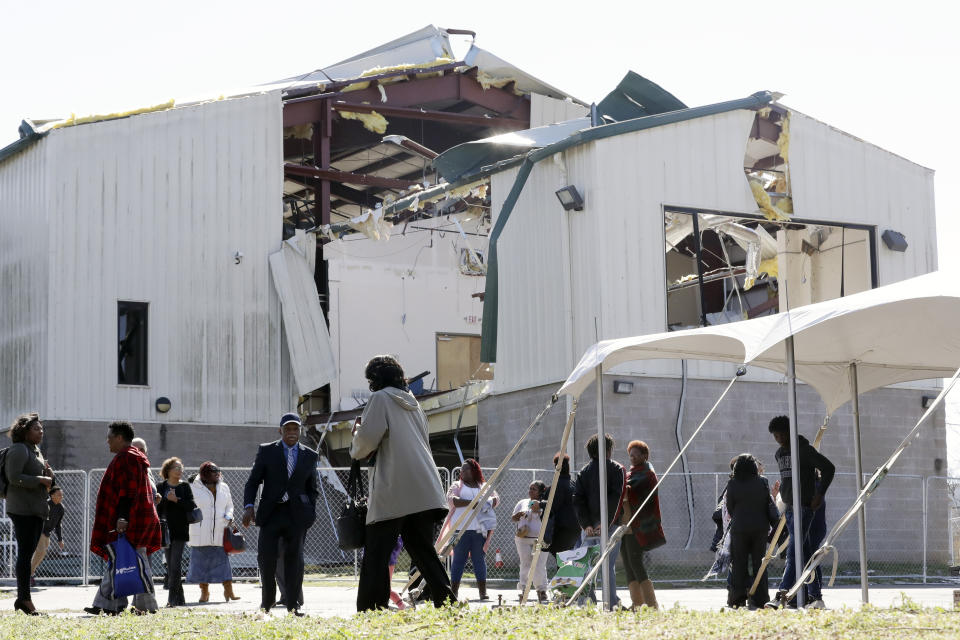 People leave a worship service at Mount Bethel Missionary Baptist Church, Sunday, March 8, 2020, in Nashville, Tenn. The congregation held their service in a tent in the parking lot near the church facilities, which were heavily damaged by a tornado March 3. (AP Photo/Mark Humphrey)