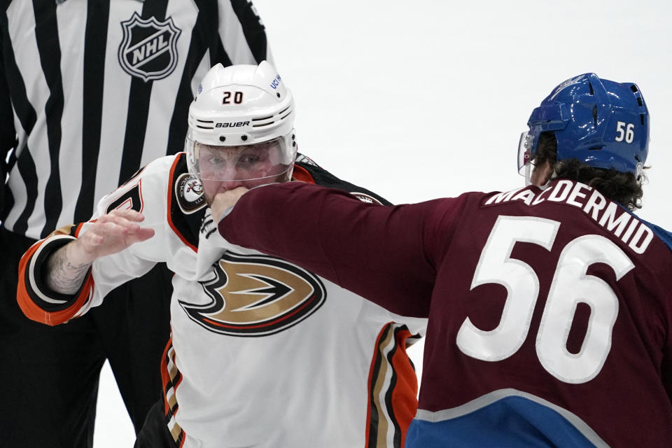 Anaheim Ducks left wing Nicolas Deslauriers, left, and Colorado Avalanche defenseman Kurtis MacDermid fight during the first period of an NHL hockey game Wednesday, Jan. 19, 2022, in Anaheim, Calif. (AP Photo/Mark J. Terrill)