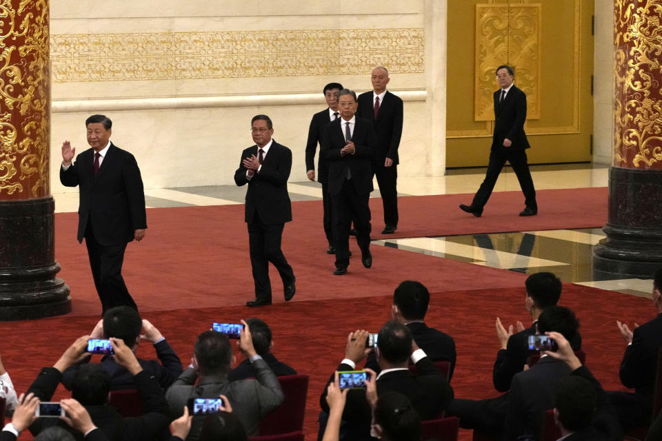 New members of the Politburo Standing Committee, from left, President Xi Jinping, Li Qiang, Zhao Leji, Wang Huning, Cai Qi, and Ding Xuexiang arrive at the Great Hall of the People in Beijing, Sunday, Oct. 23, 2022. (AP Photo/Andy Wong)