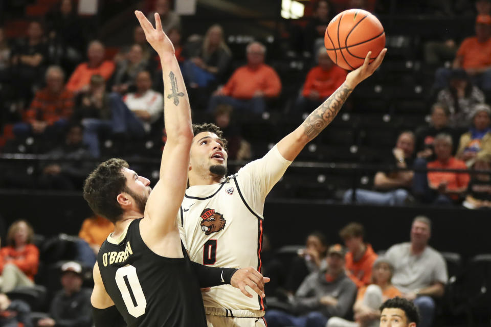 Oregon State guard Jordan Pope, right, drives to the basket as Colorado guard Luke O'Brien (0) defends during the first half of an NCAA college basketball game Saturday, March 9, 2024, in Corvallis, Ore. (AP Photo/Amanda Loman)